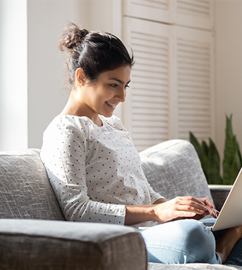 Woman on sofa with laptop